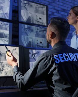 Security guards monitoring modern CCTV cameras indoors