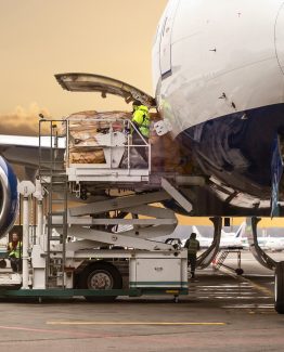 Loading cargo on the plane in airport, view through window