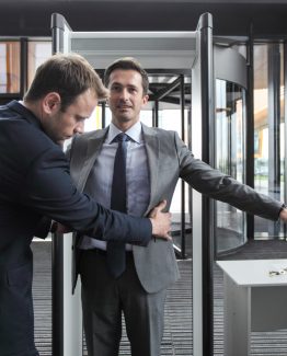 Security man check businessman at entrance in office building or airport